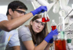 Double Dawgs students in lab red beaker-h