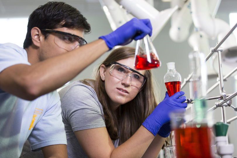 Double Dawgs students in lab red beaker-h
