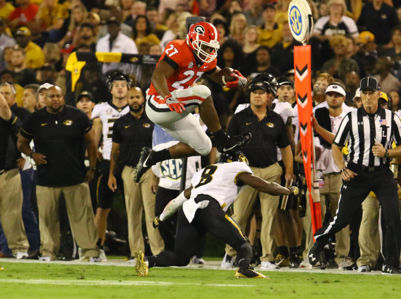 Georgia tailback Nick Chubb leaps over a Missouri defender during Saturday’s Homecoming victory. (Photo: Andy Harrison)