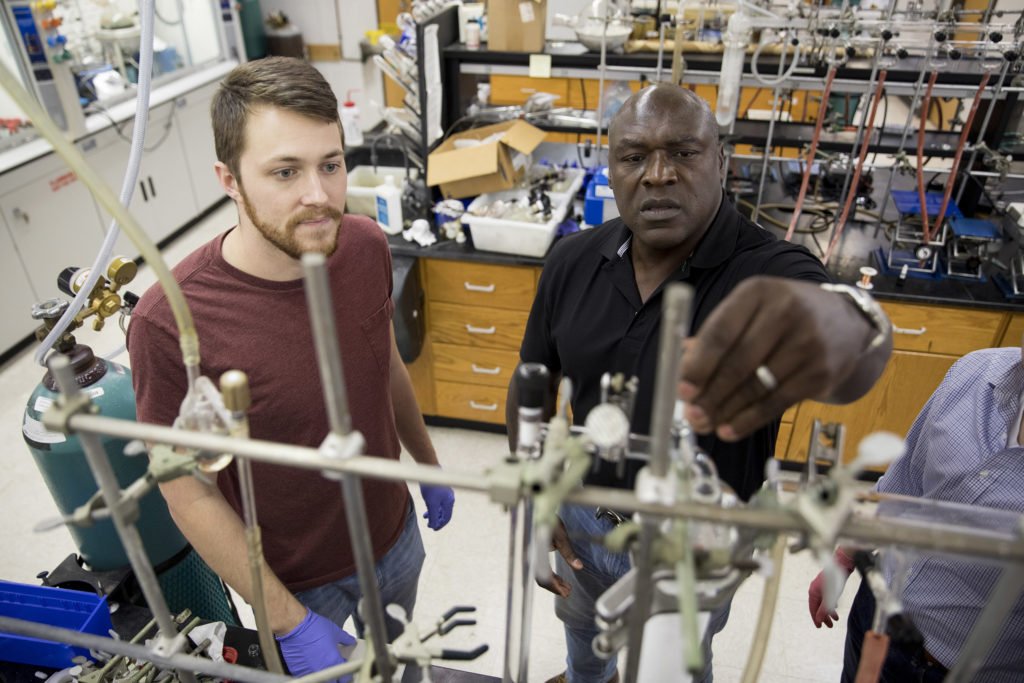 Gregory Robinson, Franklin Professor in the department of chemistry, works with a student in his research laboratory.