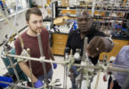 Gregory Robinson, Franklin Professor in the department of chemistry, works with a student in his research laboratory.