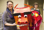 Melisa Cahnmann-Taylor (left), a professor in the UGA College of Education, and Athens artist Rae Kretzer hold a Chinese dragon similar to what will be made next month as part of Lunar New Year festivities celebrating the Big Read book, “To Live.” Kretzer will guide participants in building the dragons as part of a workshop Feb. 10-11 at the State Botanical Garden of Georgia. (Photo by Kristen Morales)