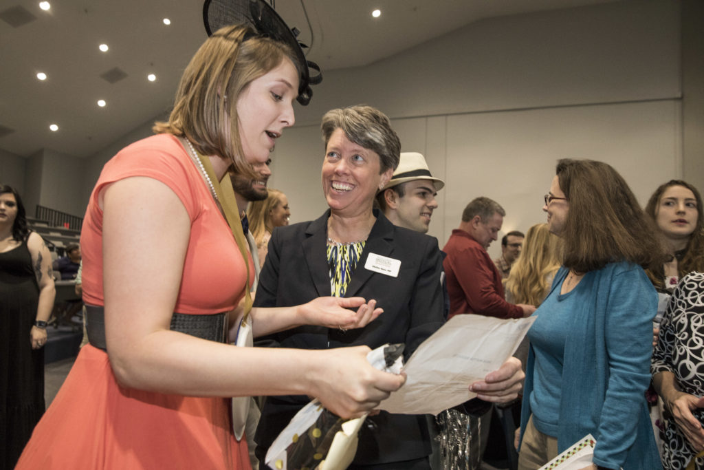 Luci Cotten showing her letter to Campus Dean Shelley Nuss.