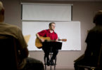 Michael McGough plays guitar and sings with a group of men at Living Hope Church during his lunch break.
