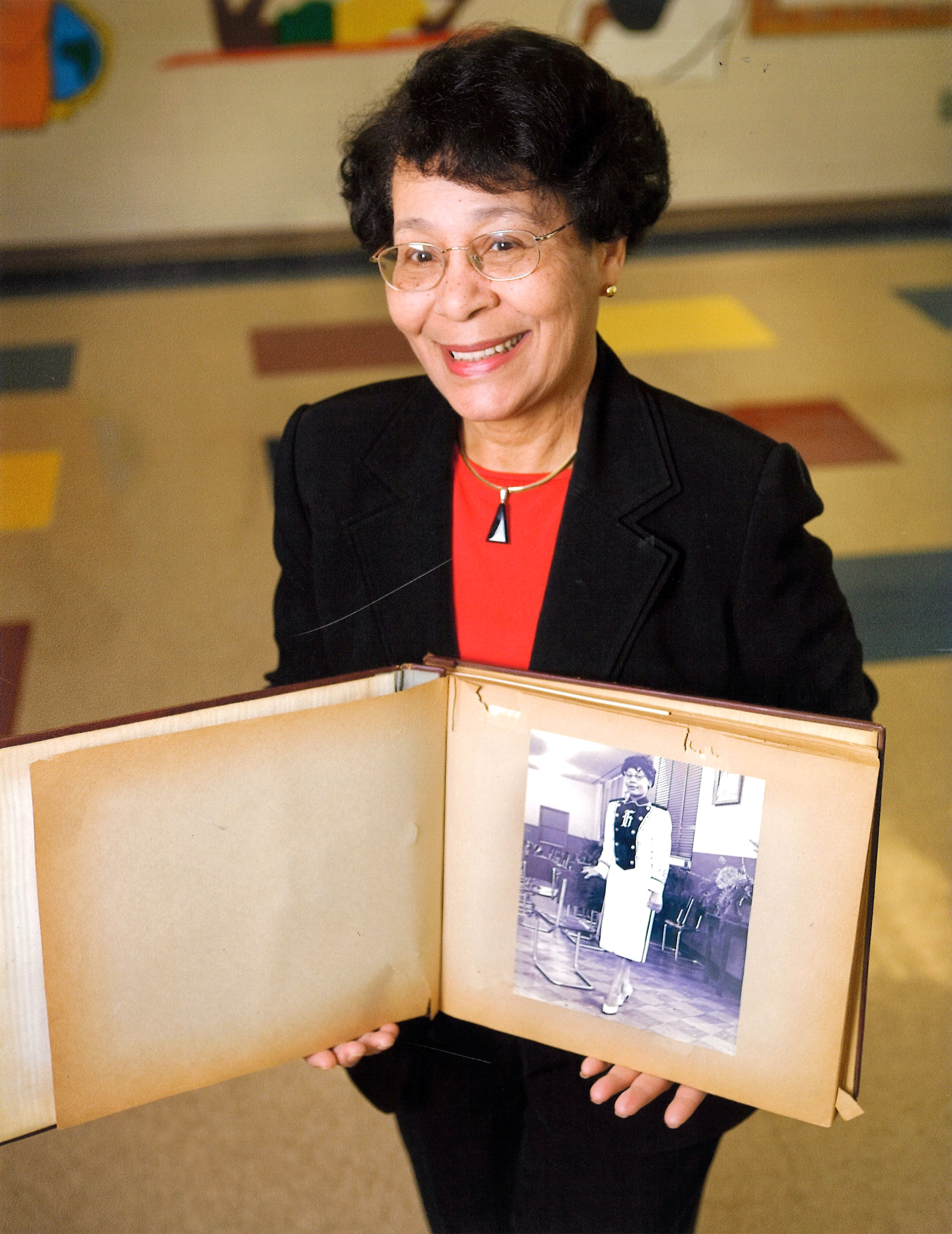 Early holds up a photo of herself at John Hope Elementary School (Photo by Nancy Evelyn/UGA)