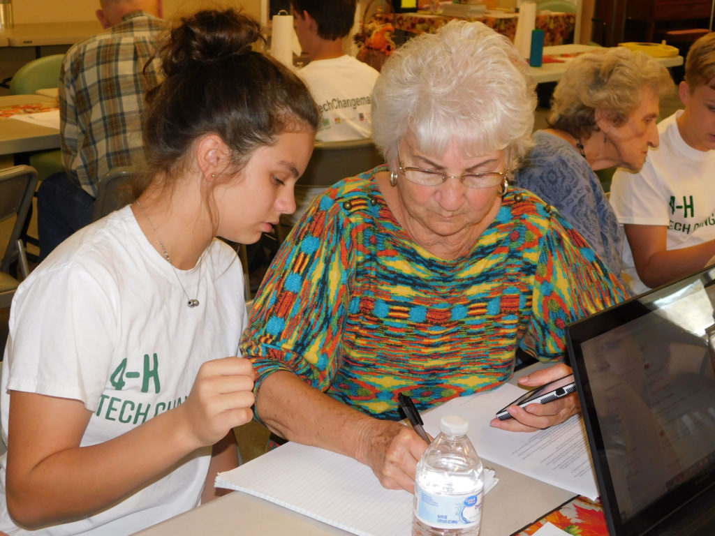 Murray County 4-H member Charlsey Richards instructs her grandmother and Tech Changemaker participant Betty Sue Grooms.