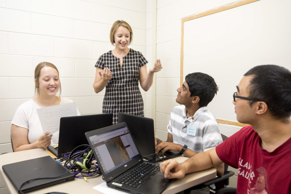 Assistant professor Dorothy Carter discusses the NASA project with undergraduates Lindsay Huizer, Jeffrey John and Guohao "Frank" Wu.