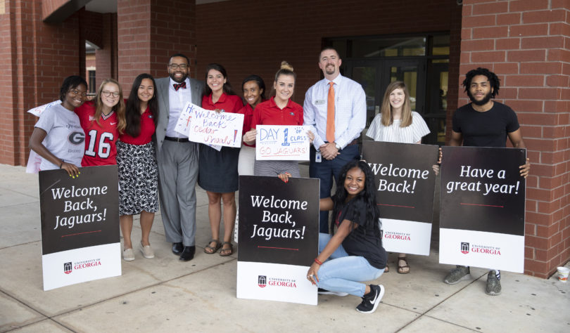 UGA students pose with Alton Standifer, fourth from, left, assistant to the president at UGA, and Cedar Shoals Principal Derrick Maxwell after welcoming students back on the first day of Clarke County Schools on Aug. 5.
