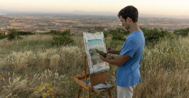 student painting a landscape in Cortona, Italy