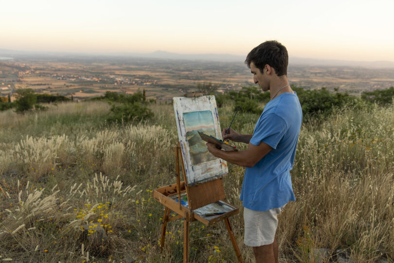 student painting a landscape in Cortona, Italy