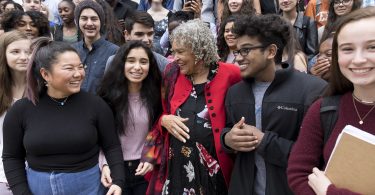 Charlayne Hunter-Gault poses with high school students.