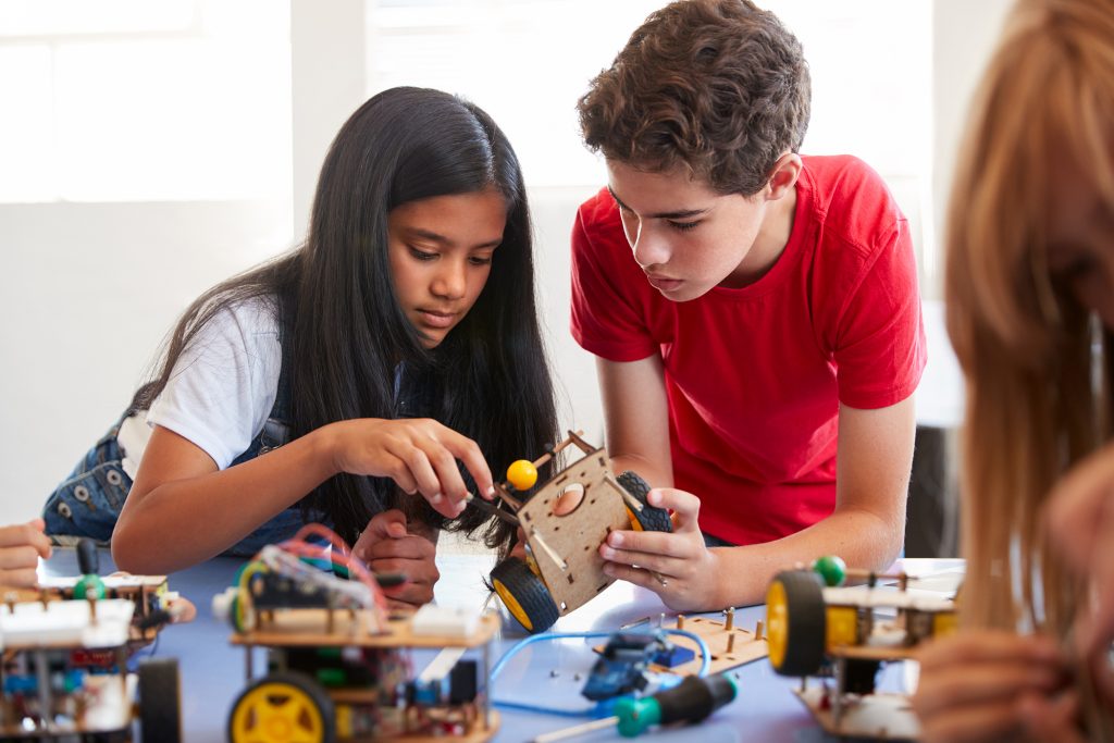 Two students building and learning to program a robot vehicle.