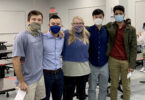 A group of five people wearing face coverings for the pandemic