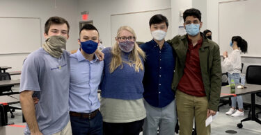 A group of five people wearing face coverings for the pandemic