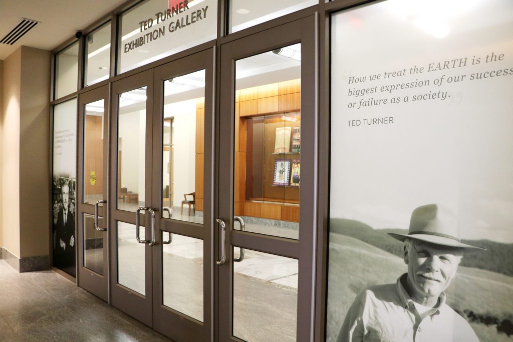 Doors and a photo of Ted Turner wearing a cowboy hat.