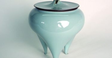 Light blue stoneware with three feet.