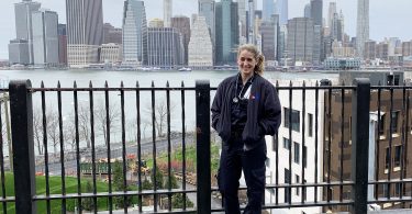 Maddy Wetterhall posing in front of New York City skyline.