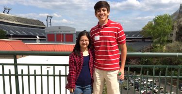 Marina and her brother, Juan Carlos Martinez, pose for a photo in front of Sanford Stadium during Marina's high school years.