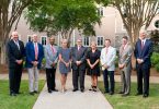 Pictured left to right: Neal J. Quirk Sr., John F. Mangan Jr., Steve C. Jones, Nancy C. Juneau, Jere W. Morehead, Bonney S. Shuman, Barry L. Storey, John H. Crawford IV and E. Howard Young. Not pictured: Executive Vice-Chair Allison C. Ausband pose for an outdoor portrait.