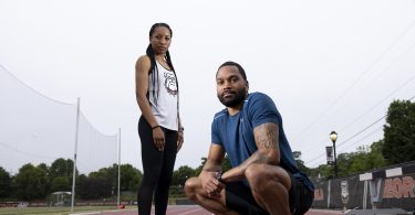 endell and Devon Williams pose on an outdoor track.