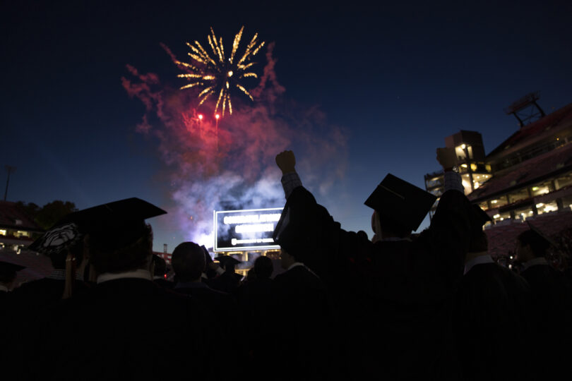 Graduates watch fireworks after Commencement.