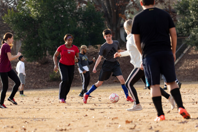 Students play a game of soccer