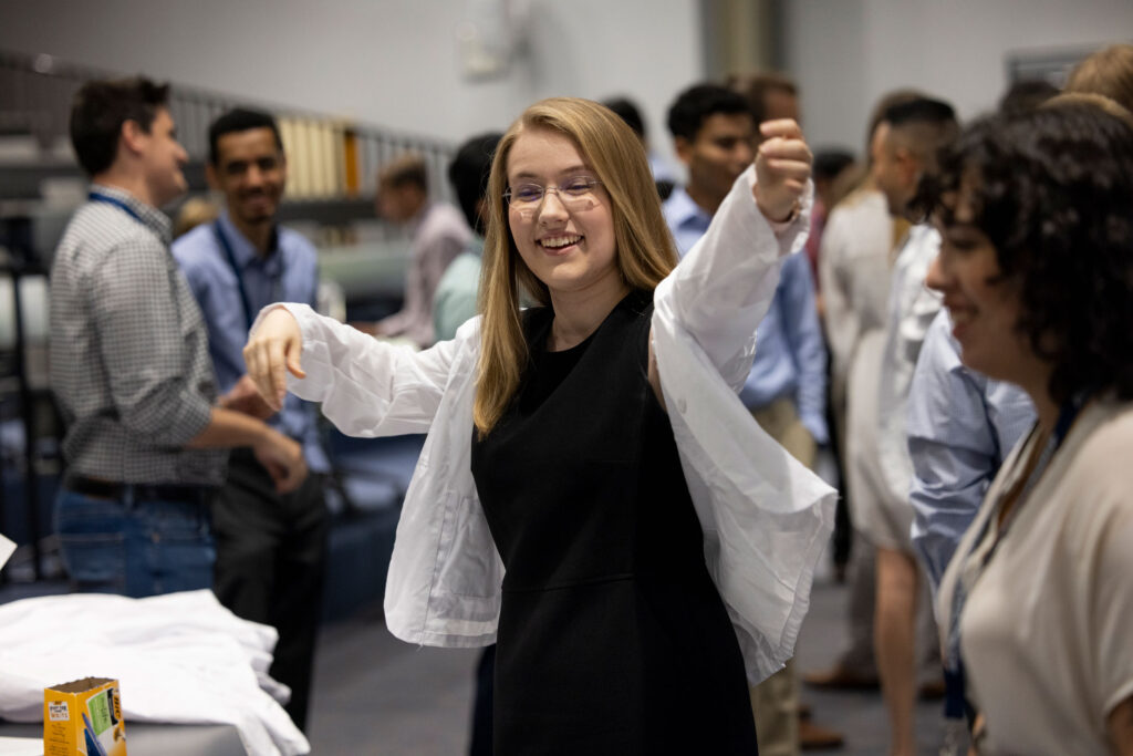 A new medical student tries on a white doctor's coat.