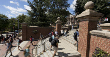Students walking up steps on campus.