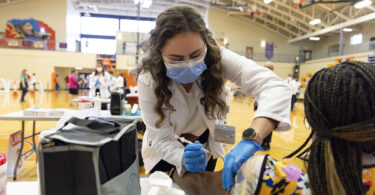 A medical student administers a vaccine .