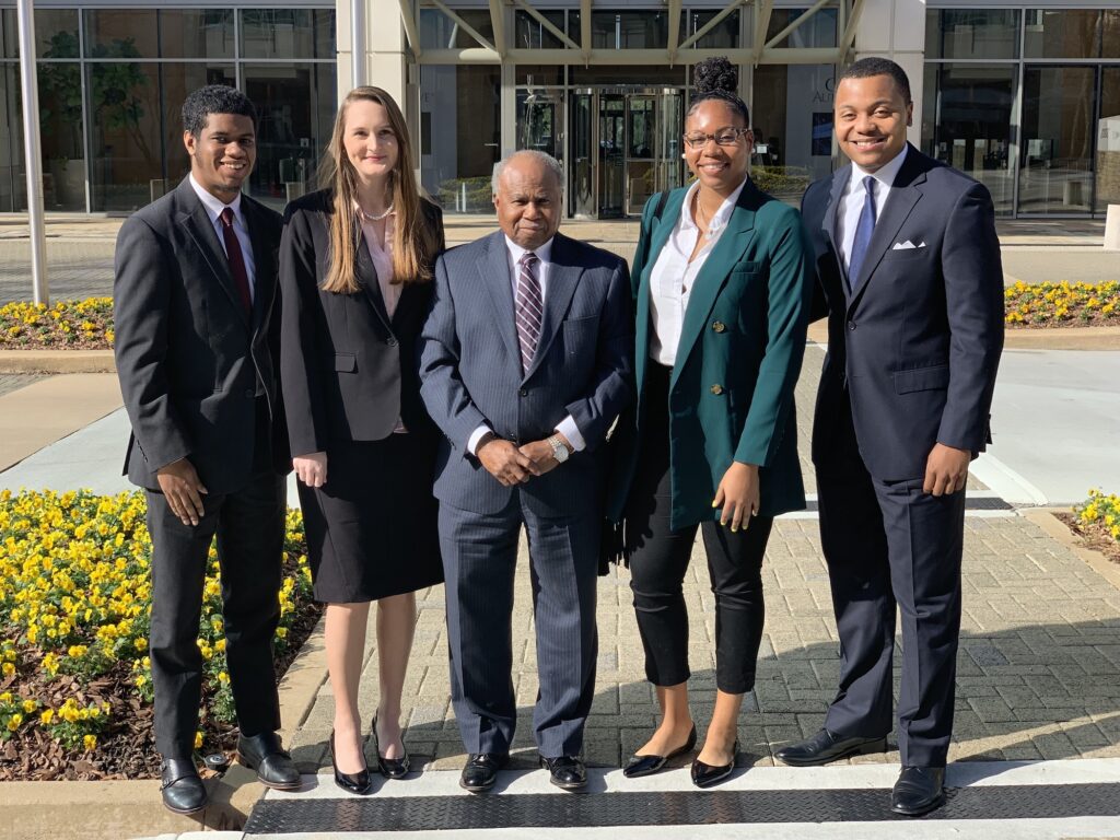 Four law students stand with Georgia Supreme Court Justice Robert Benham in the center.