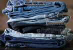 A stack of different colored jeans