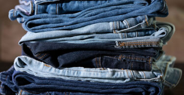 A stack of different colored jeans