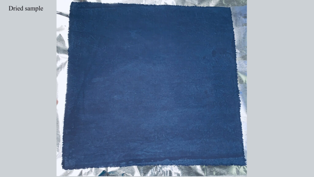 A piece of indigo-dyed cotton fabric is shown after it has dried