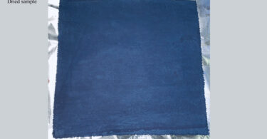 A piece of indigo-dyed cotton fabric is shown after it has dried