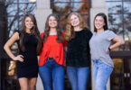 Four college freshman stand together for environmental portrait