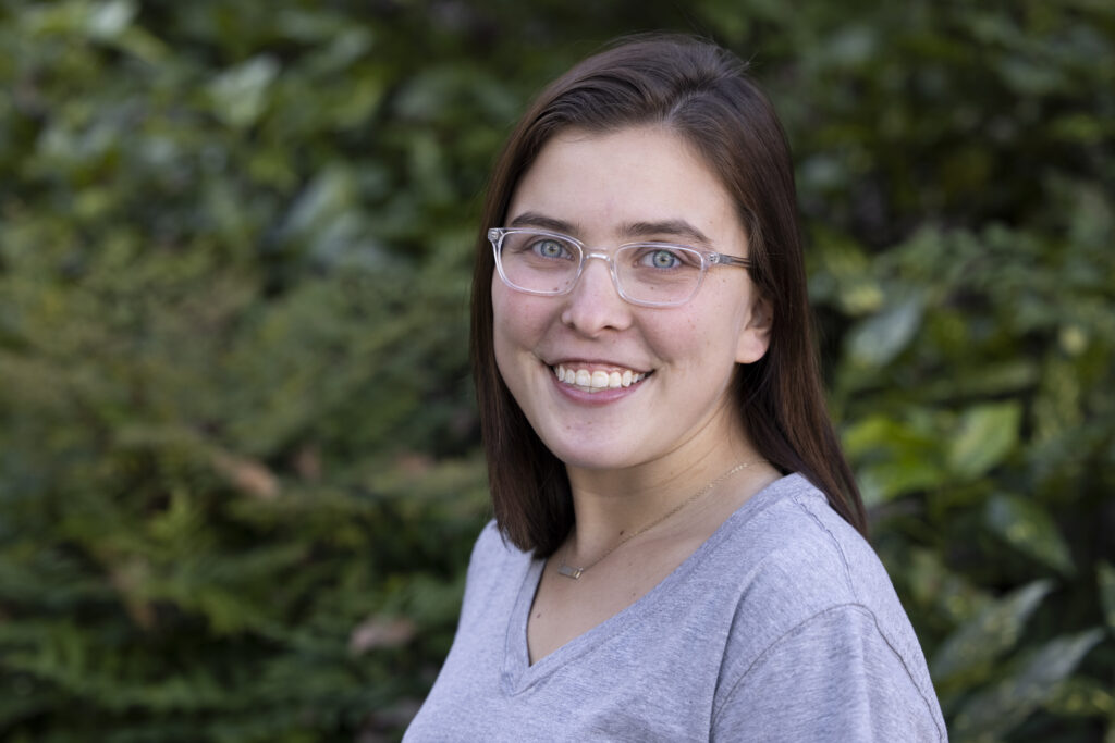 An environmental portrait of undergraduate Aubrey Fraser-Tarpley in front of Conner Hall
