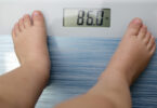 A child's feet are shown on an electronic scale that reads 86 pounds.