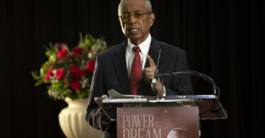Art Dunning speaking at a podium for the UGA MLK Jr. Freedom Breakfast event
