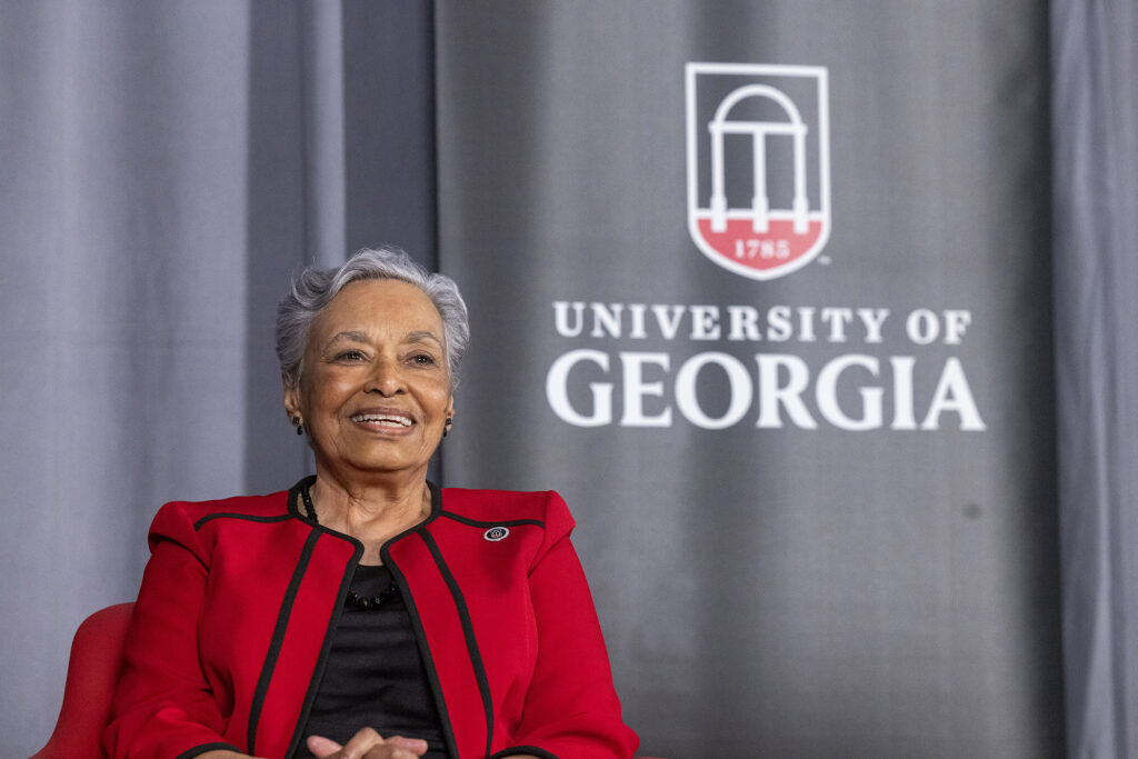 Marilyn Holmes in front of curtain at UGA