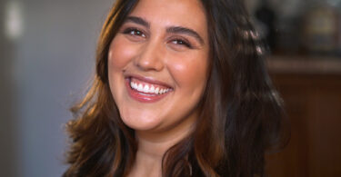 Tanya Sichynsky poses for a portrait, smiling at the camera.