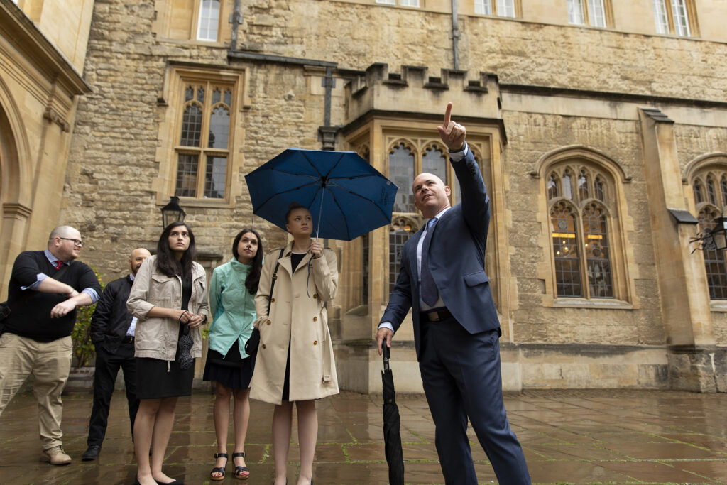 Students get a tour of Trinity College in the rain