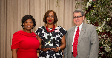 The President of UGA poses with Michelle Cook who won the Alumni Association honor for staff