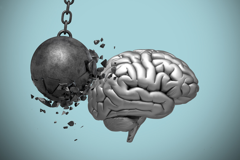 An illustration shows a wrecking ball hitting a brain.