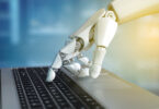 Robot hand typing on the laptop keyboard, 3d rendering isolated illustration
