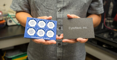 A man holds new technology from CytoNest Inc. that optimizes cell manufacturing and tissue engineering.