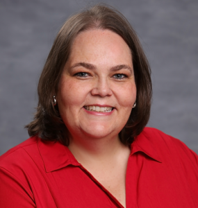 Head shot portrait of female researcher in a red button down shirt