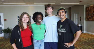 A group of young college students in casual wear smiles at the camera after winning a foundation fellowship from UGA.