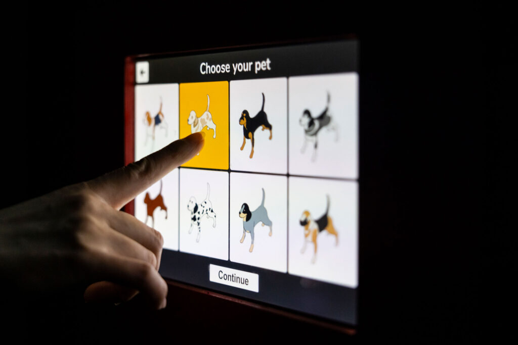 The virtual reality game allows children to pick a dog, shown here on screen, to play with as a reward for reaching their fitness goals.