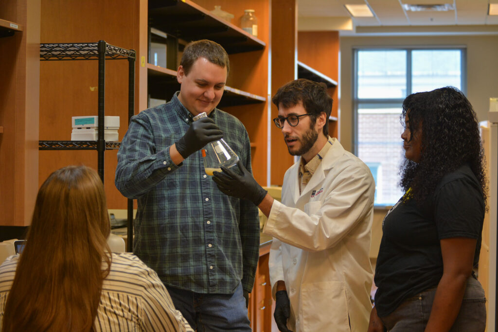 Fungus researcher Blake Billmyre works with members of his lab at the University of Georgia.