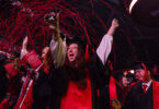 Streamers fall over the crowd during fall 2024 undergraduate commencement at Stegeman Coliseum.